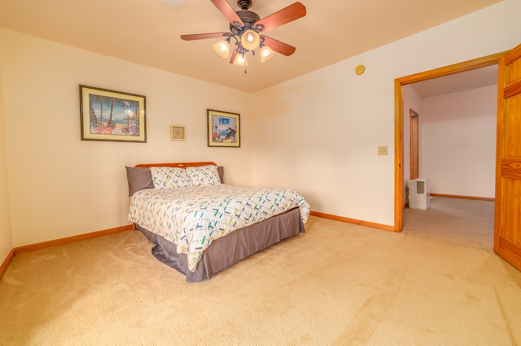 730 Dillon Oaks Drive Murphy, NC 28906 - Photo 32 of 38 a spacious bedroom with a bed and a table