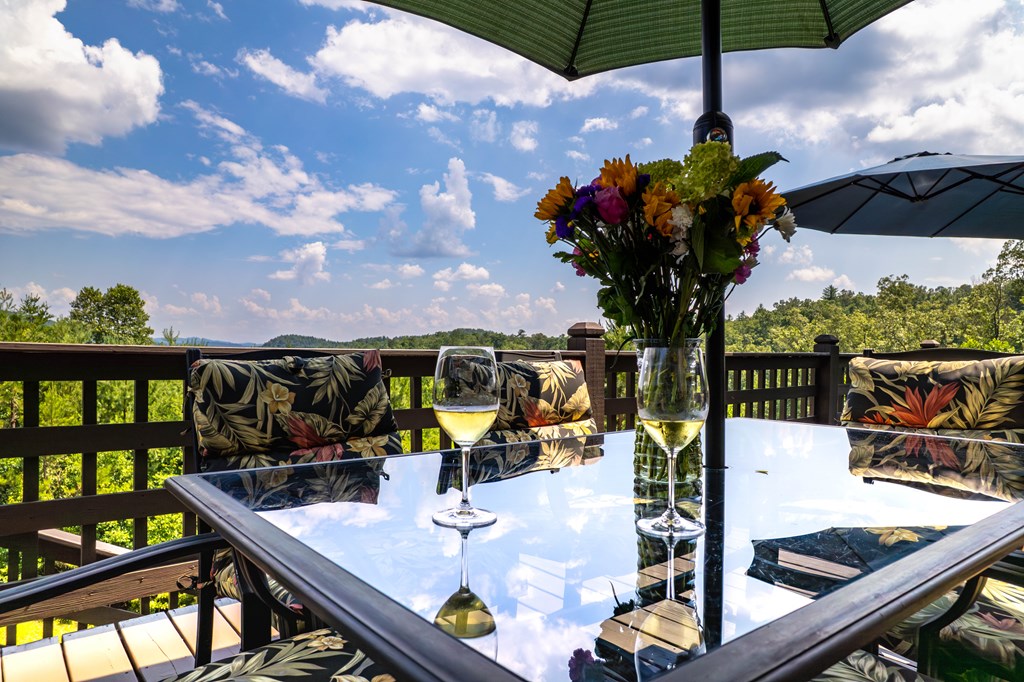 730 Dillon Oaks Drive Murphy, NC 28906 - Photo 6 of 38 a view of a balcony with chairs and a umbrella