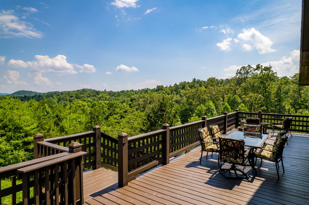 730 Dillon Oaks Drive Murphy, NC 28906 - Photo 10 of 38 a view of a roof deck with table and chairs with wooden floor and fence