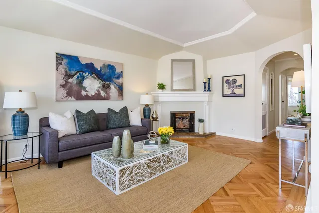 a living room with furniture and a fireplace