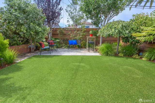 a view of backyard with seating and green space
