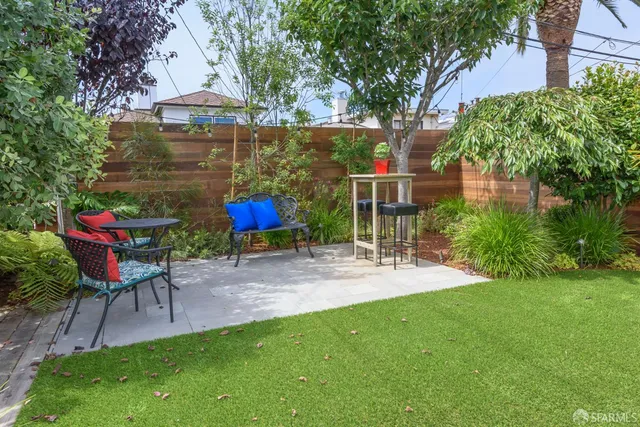a view of patio with table and chairs under an umbrella