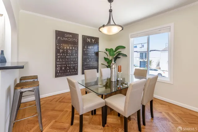 a view of a dining room with furniture window and wooden floor