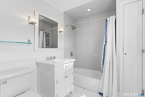 a bathroom with a sink toilet tub and shower
