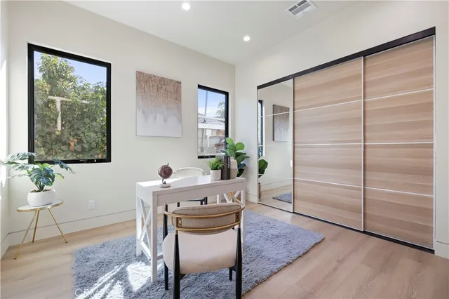 a bedroom with a bed and a painting on the wall