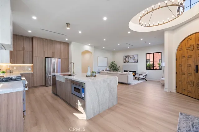 a large kitchen with stainless steel appliances lots of counter top space