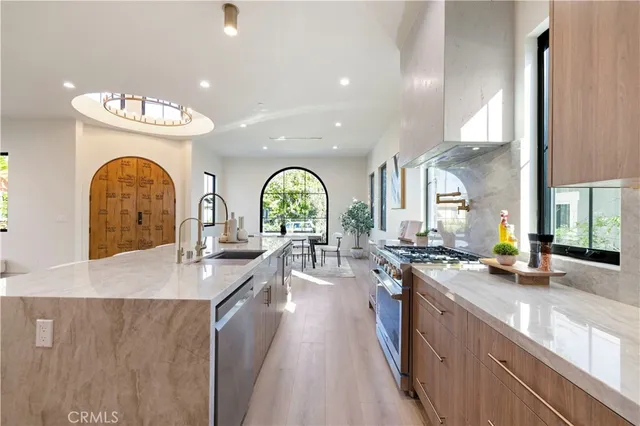 a view of a kitchen with faucet cabinets dining table and chairs
