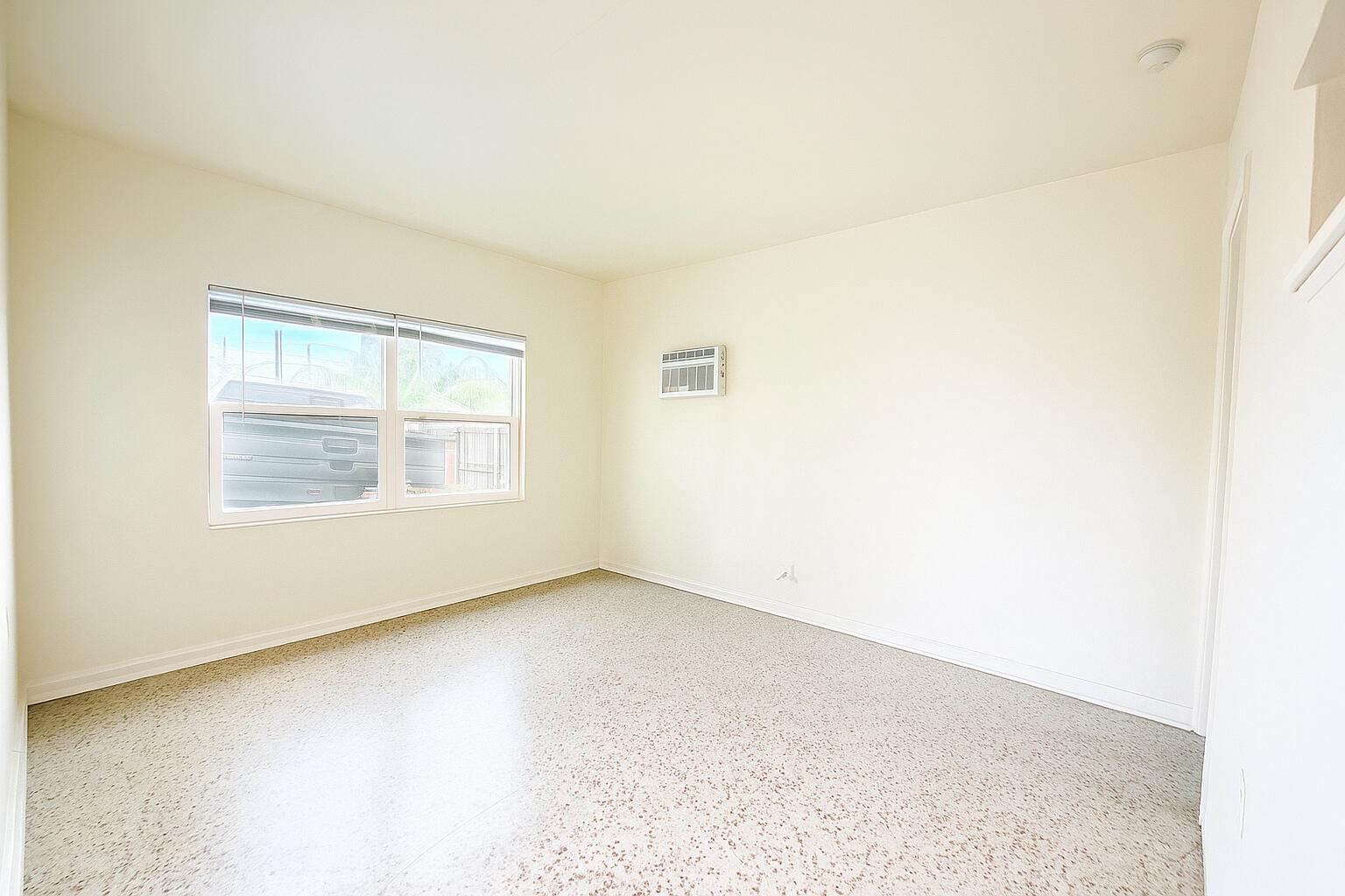 528 58th Street, Unit 1/2 West Palm Beach, FL 33407 - Photo 3 of 8 an empty room with a window