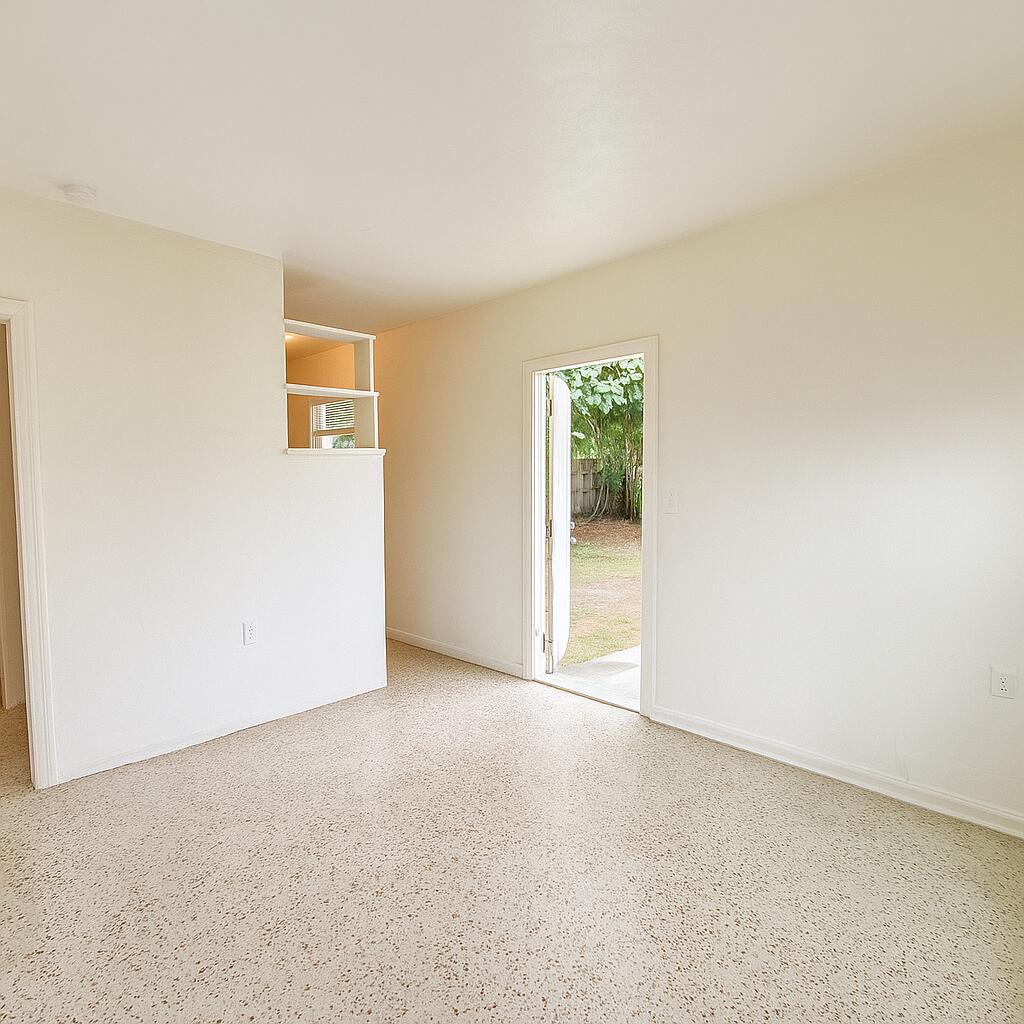 528 58th Street, Unit 1/2 West Palm Beach, FL 33407 - Photo 5 of 8 an empty room with windows