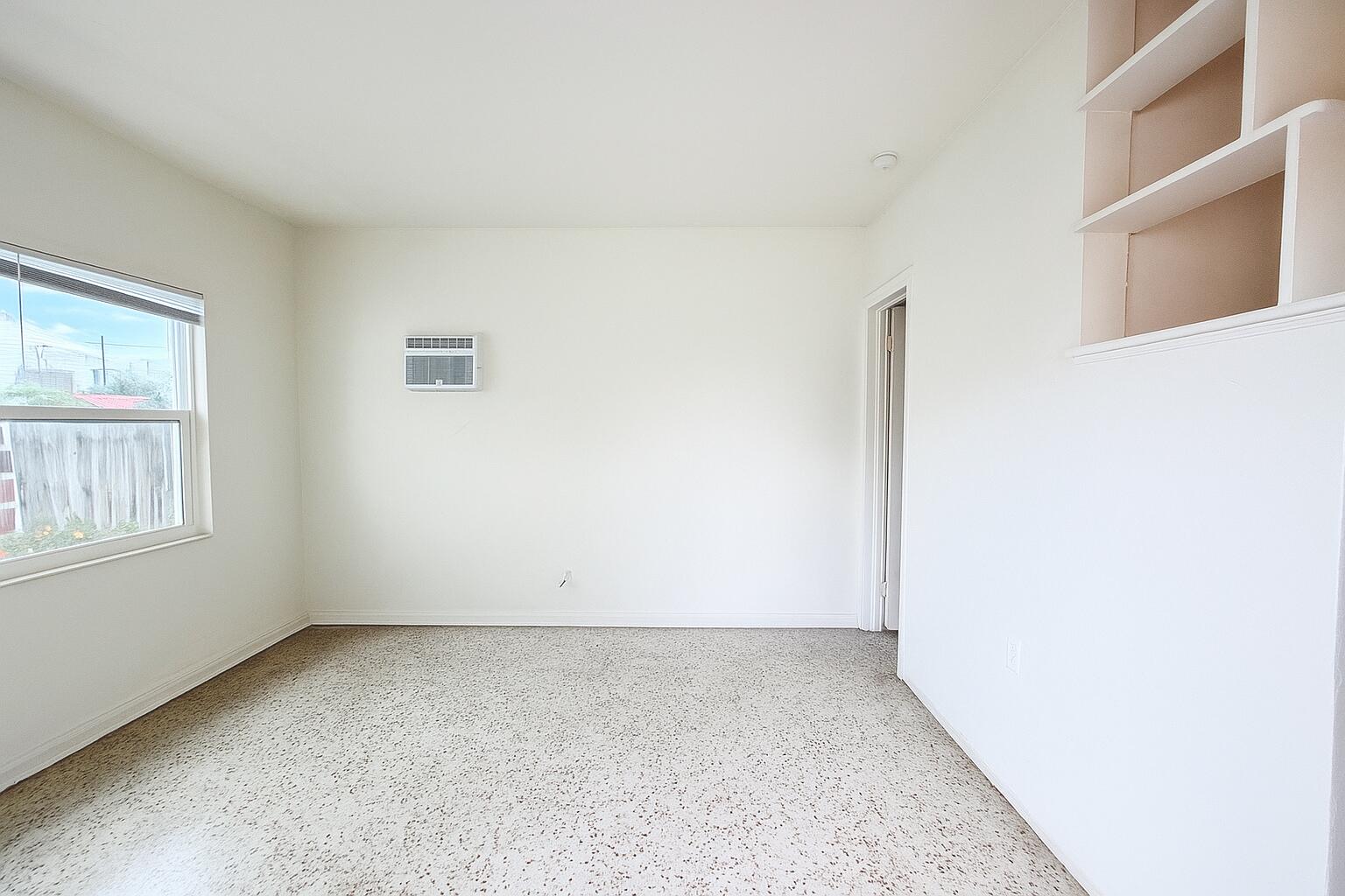 528 58th Street, Unit 1/2 West Palm Beach, FL 33407 - Photo 6 of 8 an empty room with windows