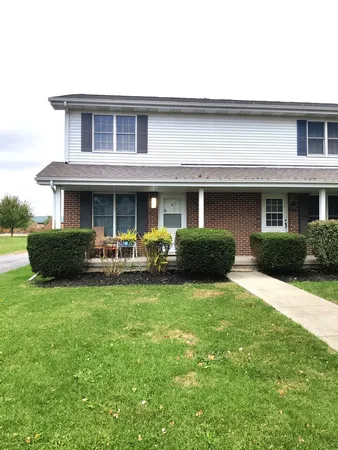 a view of a house with a yard porch and sitting area