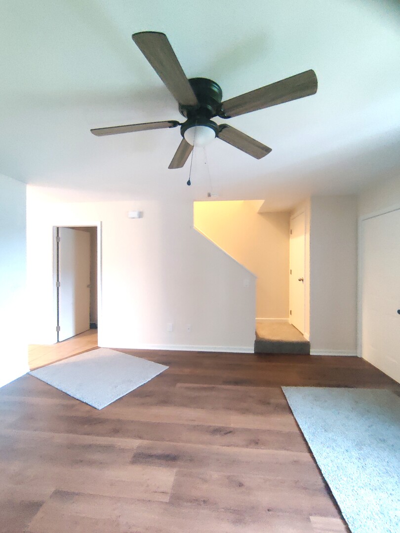 117 Colonial Parkway, Unit A Yorkville, IL 60560 - Photo 3 of 12 a view of a big room with wooden floor and windows