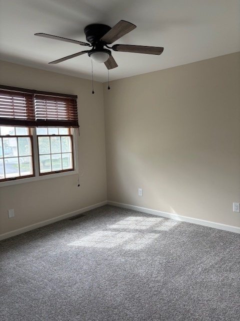 117 Colonial Parkway, Unit A Yorkville, IL 60560 - Photo 8 of 12 an empty room with a window