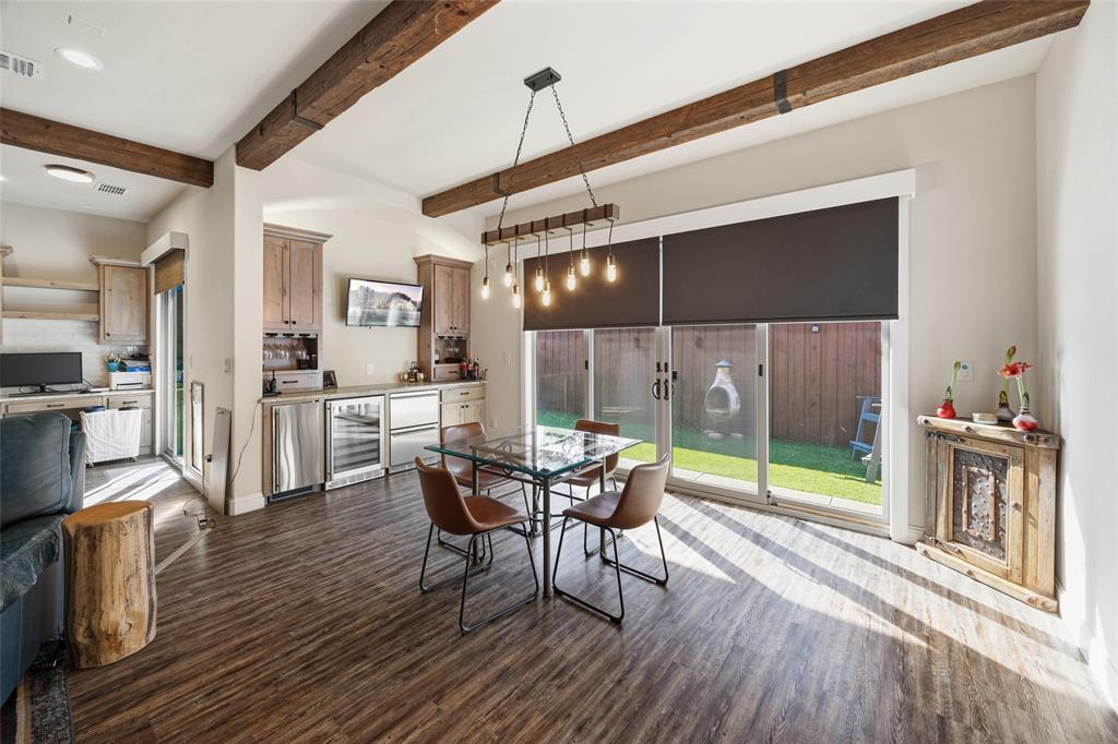 3105 Pastor Street Dallas, TX 75212 - Photo 15 of 28 Dining space featuring beverage cooler, dark wood finished floors, and beam ceiling