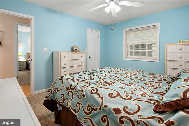 a bedroom with a bed and a dresser