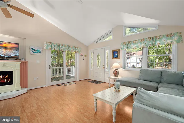 a living room with furniture wooden floor and dining table