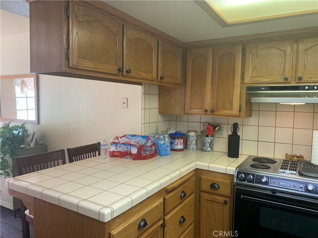 40513 Saddleback Road Bass Lake, CA 93604 - Photo 6 of 11 a kitchen with stainless steel appliances a stove a sink and cabinets