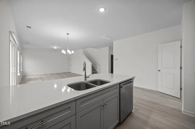 a view of a kitchen with a sink and a refrigerator