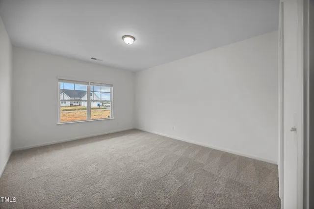a living room with furniture and a view of kitchen