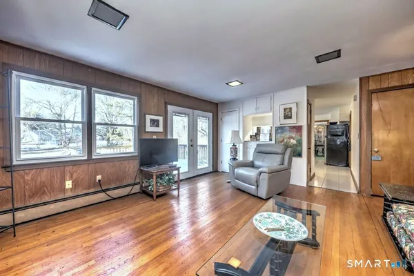 a living room with furniture and a wooden floor