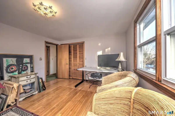 a bed sitting in a bedroom next to a window