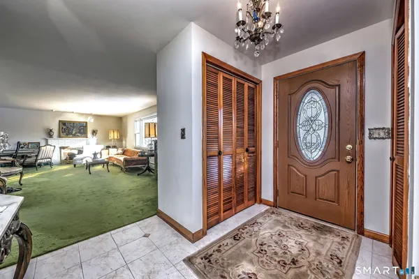 a view of living room filled with furniture and a clock