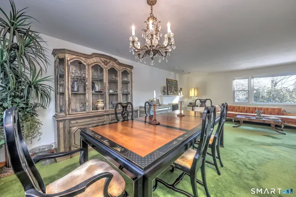 a dining room with furniture and a floor to ceiling window