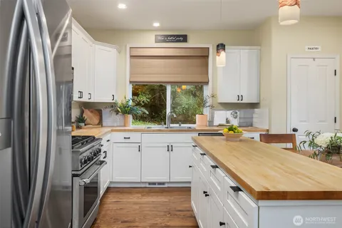 a kitchen with a sink stove and refrigerator