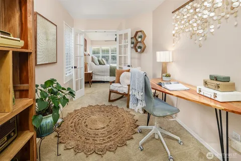 a living room with furniture and a potted plant