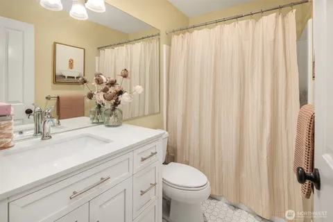 a bathroom with a sink a toilet and mirror