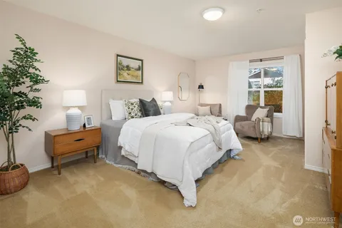 a bed room with furniture and a potted plant