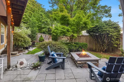a view of a patio with table and chairs and potted plants