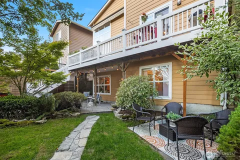 a front view of a house with a yard and outdoor seating