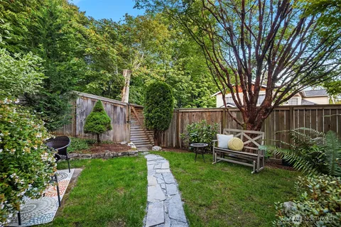 a view of a house with backyard sitting area and garden
