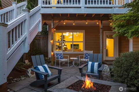 a view of balcony with two chairs and a potted plant