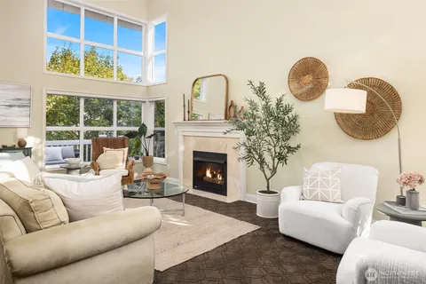 a living room with furniture a fireplace and window