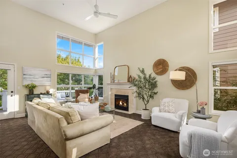 a living room with fireplace furniture and a large window