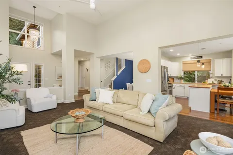 a living room with furniture and kitchen view