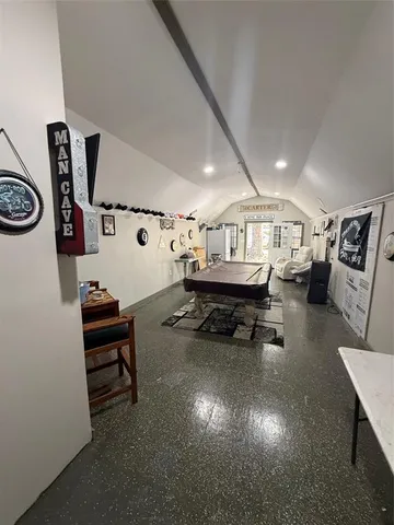 a living room with furniture and a mirror