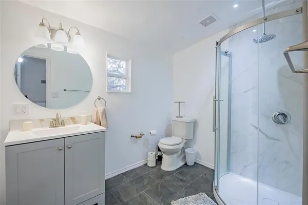 a bathroom with a glass shower door