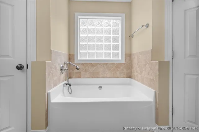 a white bath tub sitting next to a window