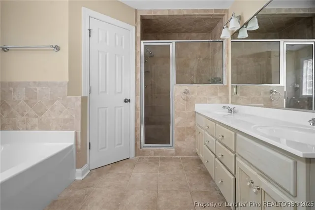 a bathroom with a tub sink and mirror