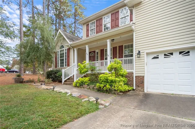 a view of a house with a yard and plants