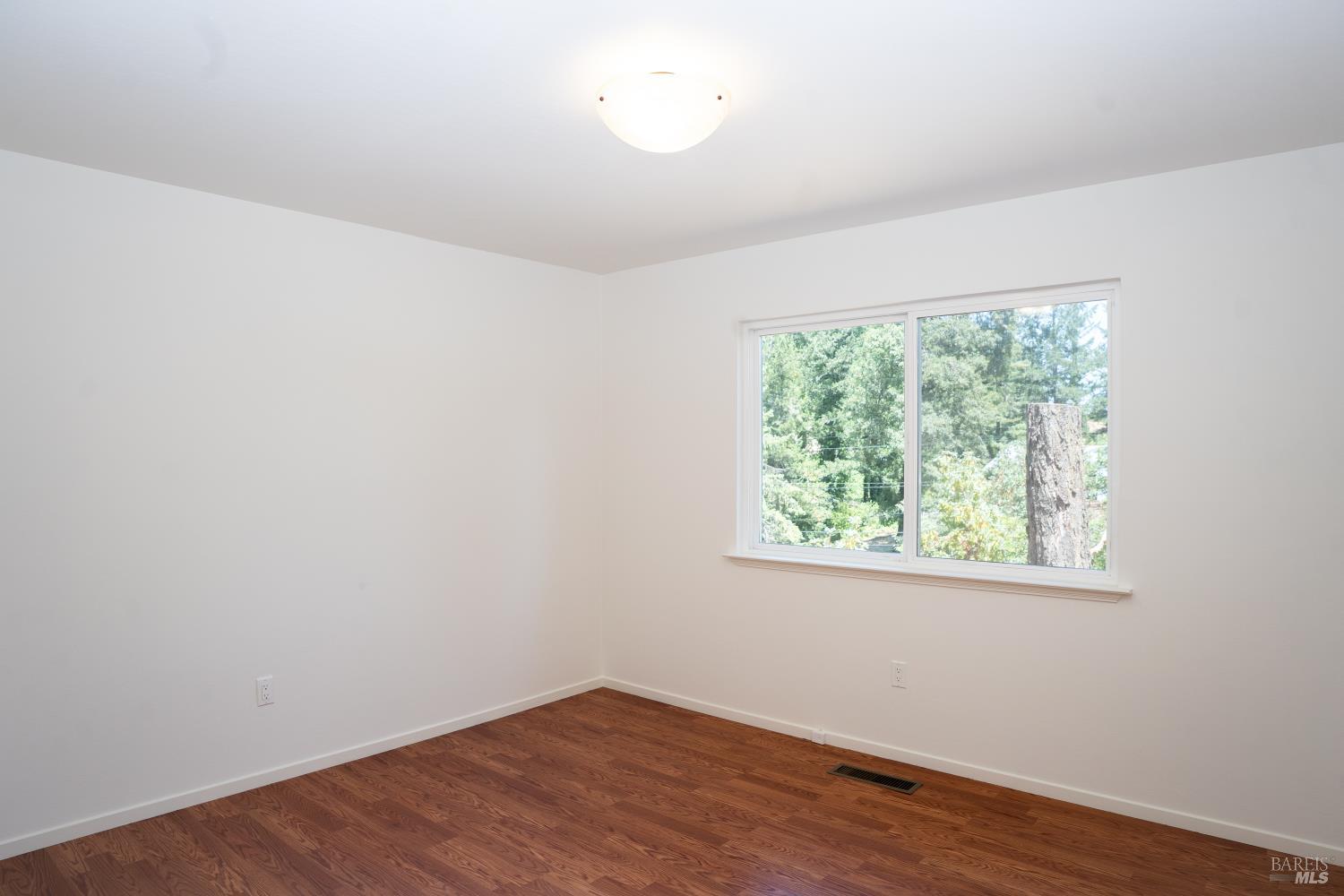120 Cold Springs Road Angwin, CA 94508 - Photo 11 of 23 an empty room with wooden floor and windows