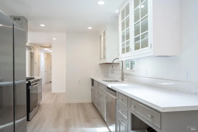 a kitchen with a sink appliances and cabinets