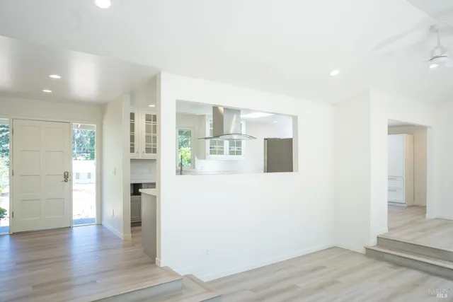 a view of a kitchen with wooden floor and a refrigerator