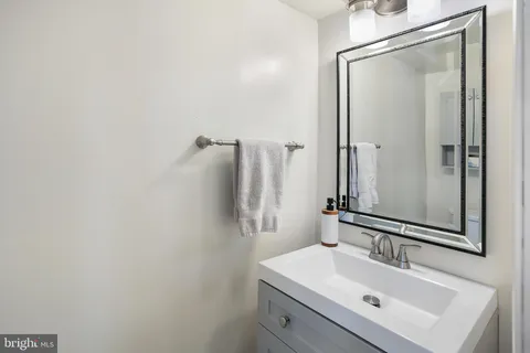 a bathroom with a sink mirror and vanity