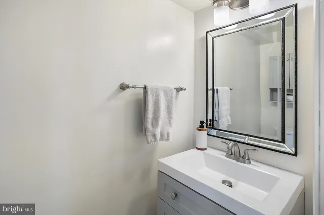 a bathroom with a sink mirror and vanity