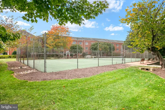 front view of a brick house with a yard