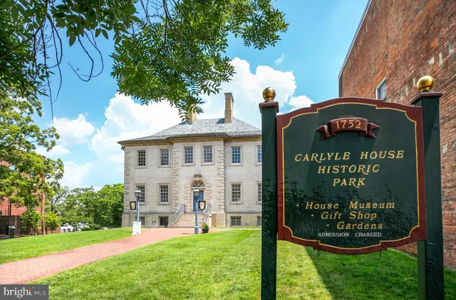 a patio with a table and chairs under an umbrella